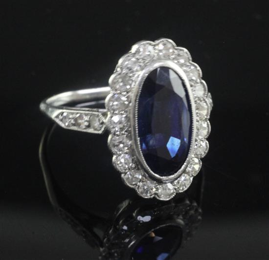 A 1940s/1950s synthetic sapphire and diamond oval cluster ring, size K.